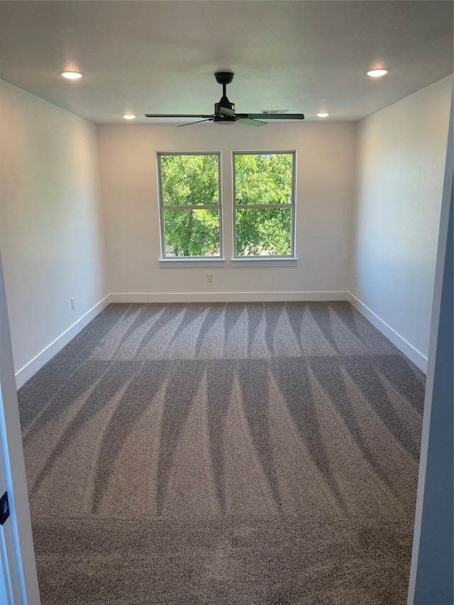 carpeted empty room featuring ceiling fan