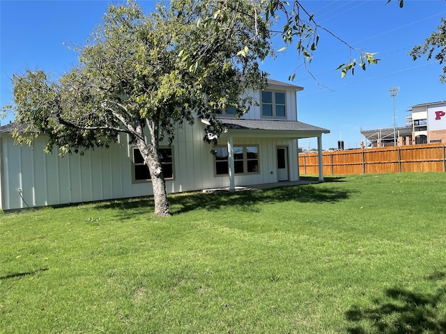 back of house with a lawn