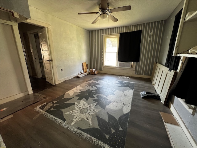 interior space featuring ceiling fan, cooling unit, and dark wood-type flooring