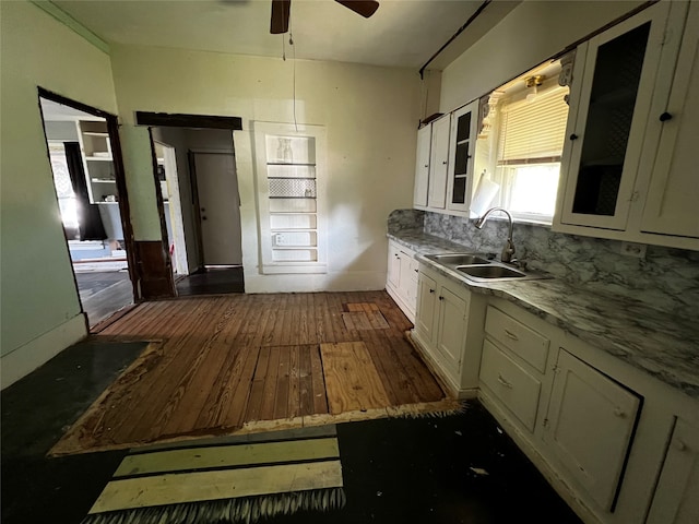 kitchen featuring backsplash, white cabinets, sink, and dark hardwood / wood-style flooring