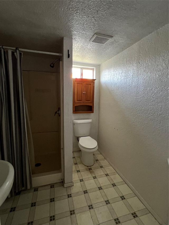 bathroom with sink, toilet, a shower with shower curtain, and a textured ceiling