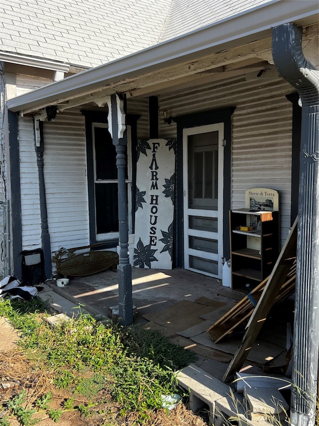 view of exterior entry with a porch