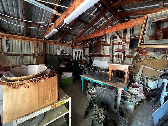 misc room with concrete flooring, vaulted ceiling, and a workshop area