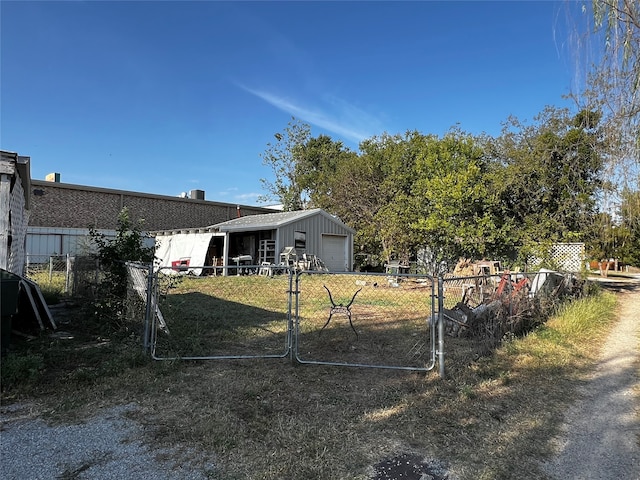 view of yard with a garage and an outbuilding