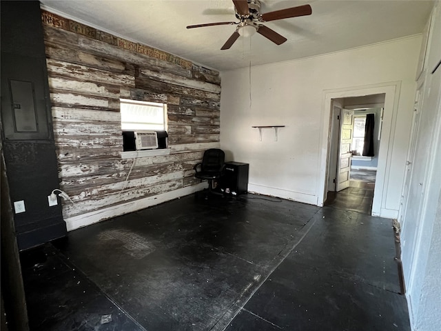 unfurnished living room featuring wooden walls, ceiling fan, and cooling unit