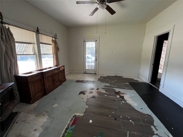 foyer entrance featuring ceiling fan and a healthy amount of sunlight