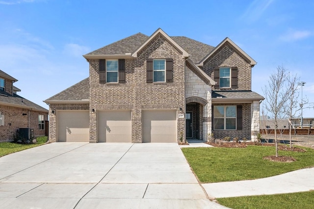 view of front of home with brick siding, a shingled roof, driveway, stone siding, and a front yard