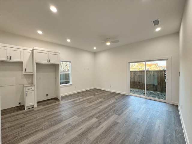 interior space featuring ceiling fan, a healthy amount of sunlight, and hardwood / wood-style flooring