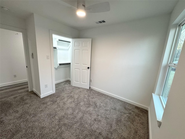 unfurnished bedroom featuring ceiling fan, a closet, and carpet floors