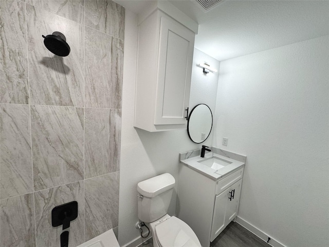 bathroom with wood-type flooring, toilet, and vanity