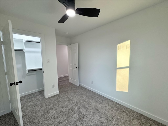 unfurnished bedroom with ceiling fan, carpet flooring, and a closet