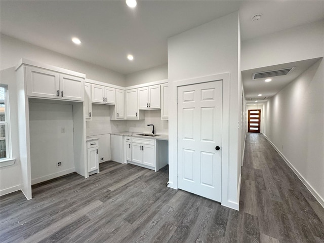 kitchen with sink, white cabinets, and dark hardwood / wood-style floors