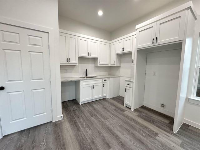 kitchen featuring dark hardwood / wood-style flooring, white cabinets, tasteful backsplash, and sink