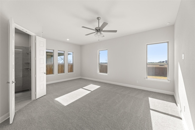 unfurnished bedroom with ensuite bath, ceiling fan, and carpet