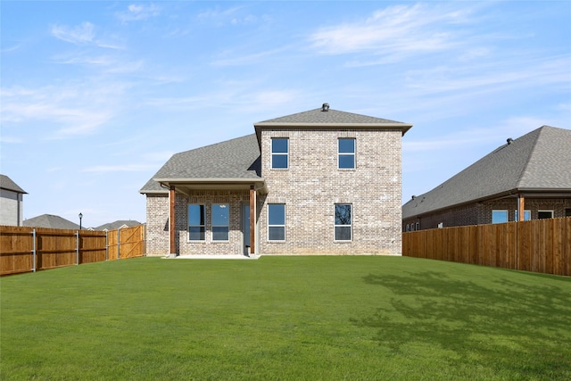 back of house featuring a yard