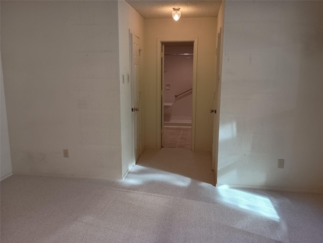 hallway with a textured ceiling