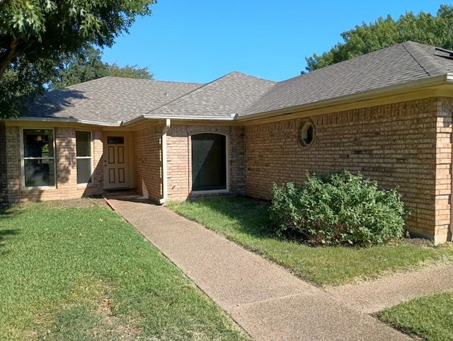 entrance to property with a lawn