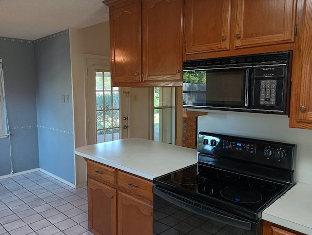 kitchen featuring light tile patterned floors and black appliances