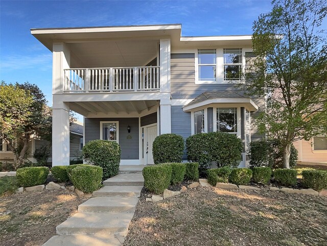 view of front of house featuring a porch and a balcony