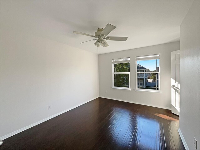 unfurnished room featuring wood finished floors, baseboards, and ceiling fan