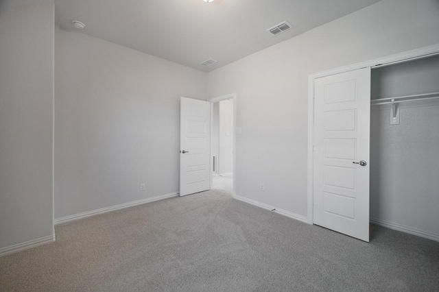 unfurnished bedroom featuring a closet, baseboards, visible vents, and carpet flooring