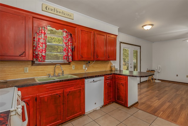 kitchen with light wood-type flooring, sink, white appliances, and a healthy amount of sunlight