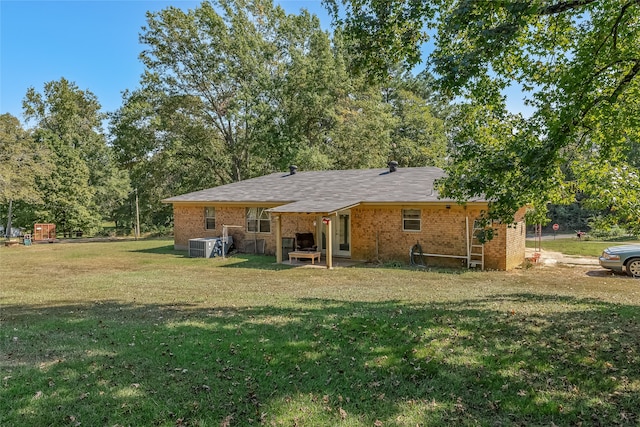 back of property with cooling unit and a yard