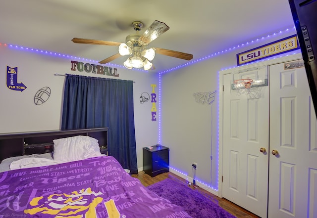 bedroom with ceiling fan, a closet, and wood-type flooring