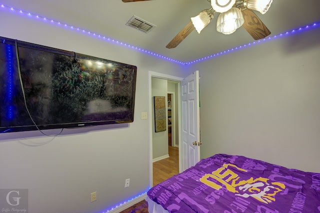 bedroom with hardwood / wood-style flooring and ceiling fan