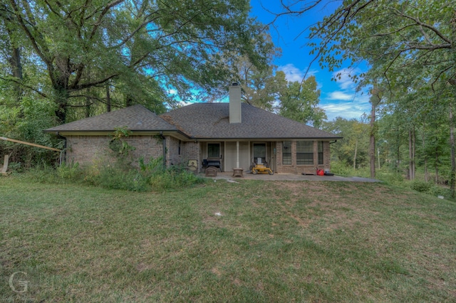 back of house with a yard