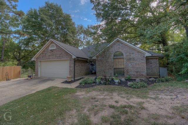 single story home featuring a front yard and a garage