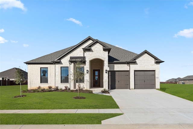 view of front of house with a front lawn and a garage