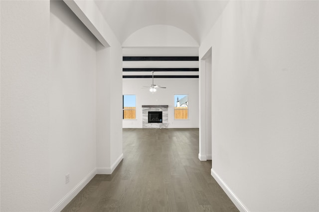 hallway featuring beamed ceiling and dark wood-type flooring