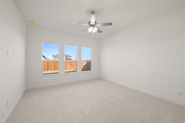 spare room with carpet floors and ceiling fan