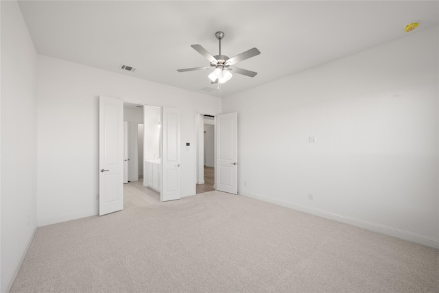 unfurnished bedroom featuring light colored carpet and ceiling fan