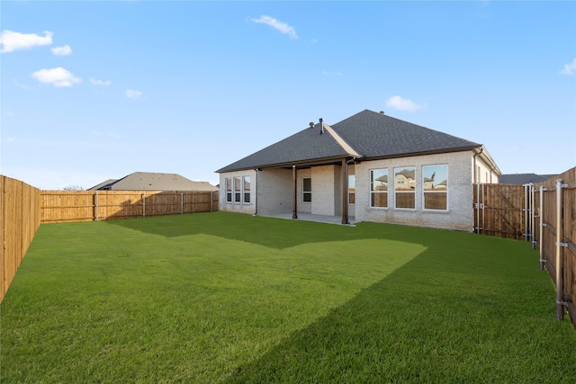 rear view of house with a yard