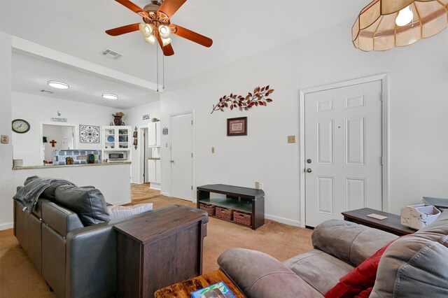 living room with ceiling fan and light colored carpet