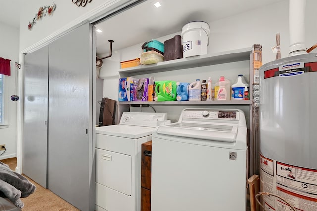 laundry area with gas water heater, carpet flooring, and washer and clothes dryer