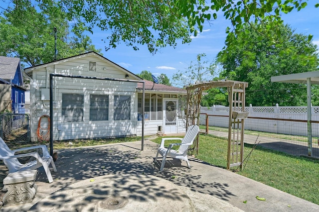 back of house featuring a yard, a pergola, and a patio