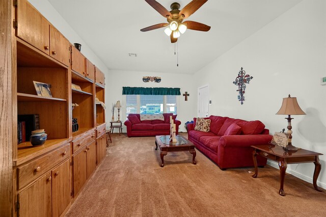 carpeted living room featuring ceiling fan