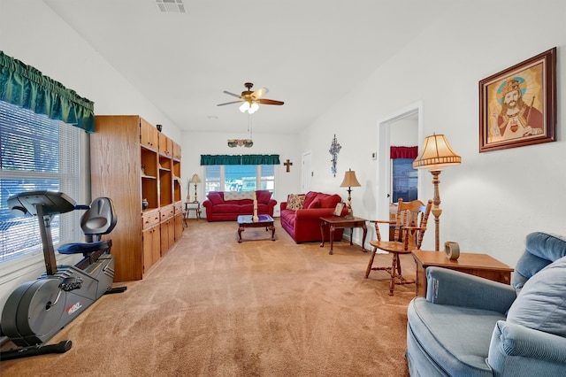 carpeted living room with ceiling fan