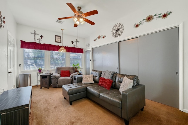 carpeted living room featuring ceiling fan