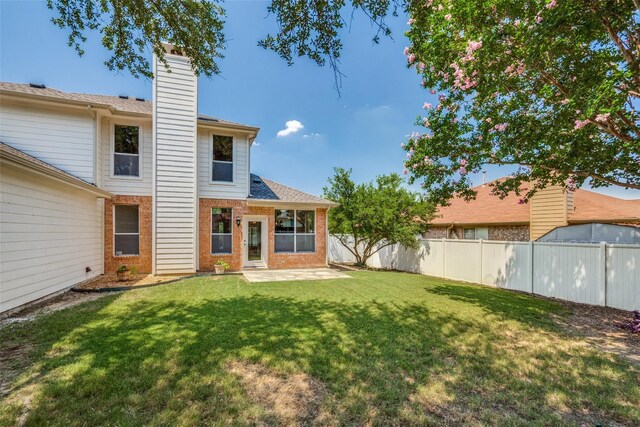 rear view of house with a lawn