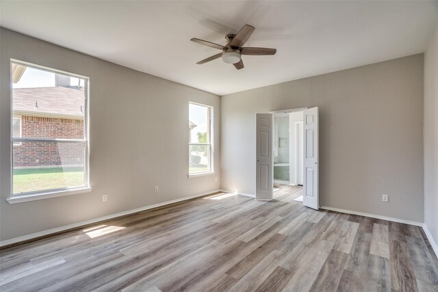 spare room with light hardwood / wood-style floors and ceiling fan