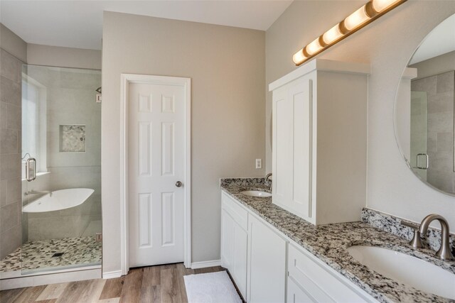 bathroom featuring vanity, an enclosed shower, and hardwood / wood-style flooring