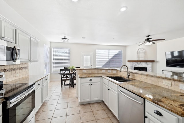 kitchen with appliances with stainless steel finishes, sink, and white cabinetry