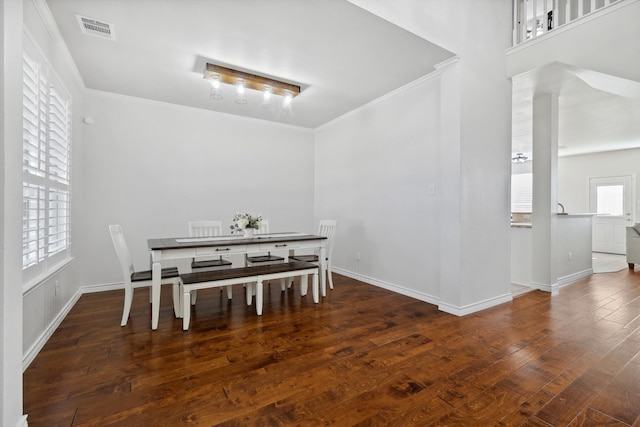 dining room featuring dark hardwood / wood-style floors and ornamental molding