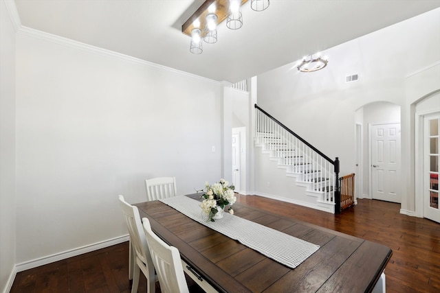 dining area with ornamental molding and dark hardwood / wood-style flooring