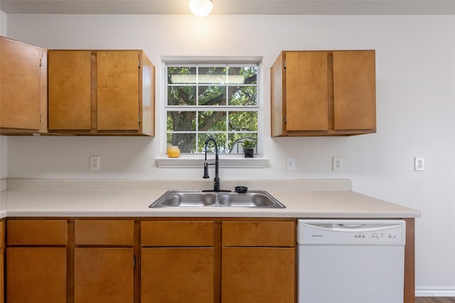 kitchen with hardwood / wood-style flooring, dishwasher, and sink