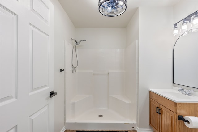 bathroom with a shower and vanity